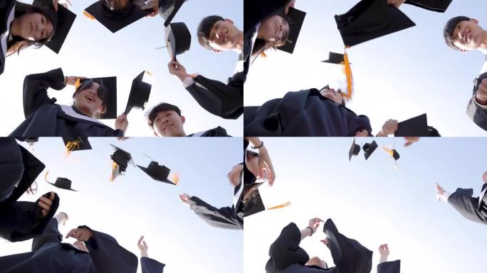 快乐的学生在空中扔毕业帽