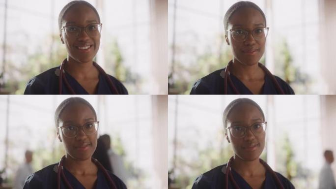 一位黑人女性医疗保健专业人员的肖像，对着镜头摆姿势，微笑着看着镜头。非洲诊所医师戴眼镜，在医院办公室
