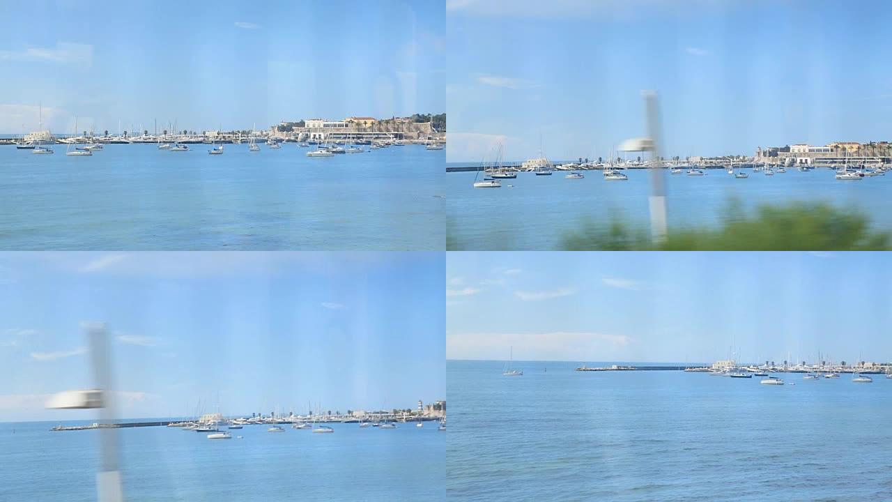 美丽的蓝色水港，系泊帆船，从火车上可以看到