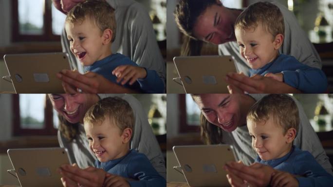 小男孩与母亲一起使用数字平板电脑拍摄的真实照片，他坐在家里的厨房里与家人进行视频通话。女人和她的儿子