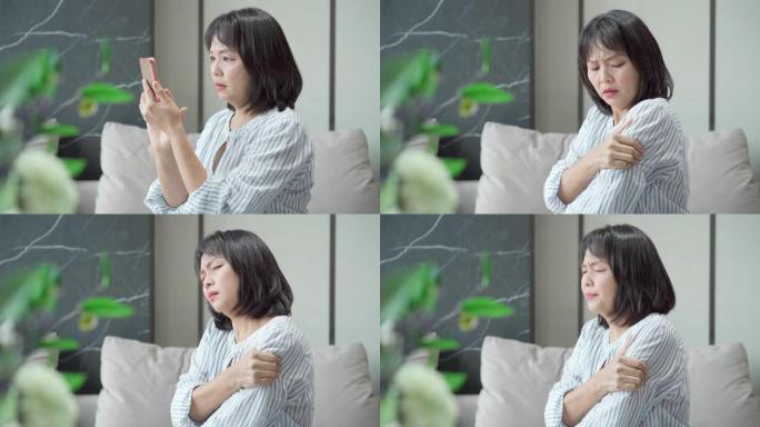 亚洲成熟女性使用智能手机痛苦感觉突然疼痛肩关节肌肉劳损