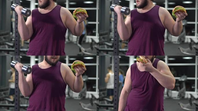 肥胖男性手拿哑铃吃汉堡，不健康的营养问题