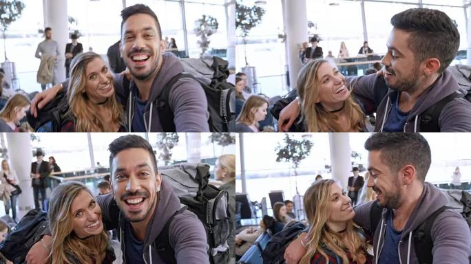 年轻的高加索夫妇在等待登机时在机场进行直播智能手机视频