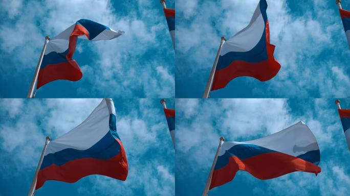 旗杆上的俄罗斯国旗在风中挥舞着蓝天，云彩