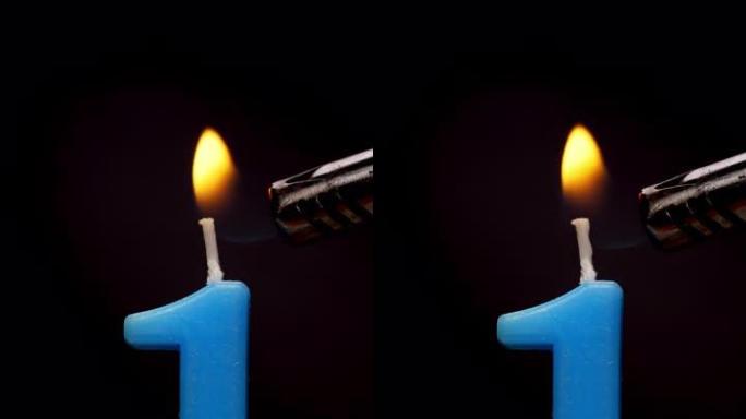 4k镜头前视图，燃烧第一号生日蜡烛，黑色背景上有火。