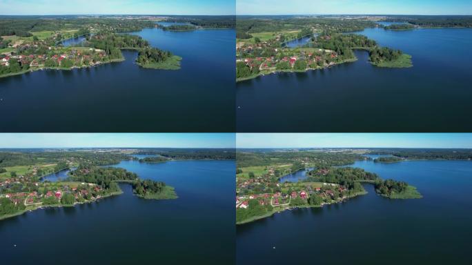 波兰平静湖与岛屿的雄伟鸟瞰图。令人印象深刻的湖边房屋。天堂湖畔的村舍。和平反映在水上。绿树、森林和丘