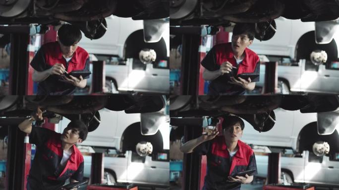 汽车服务、维修、保养理念。机械师在服务站检查汽车。车辆服务维护亚洲男子在车库检查汽车。