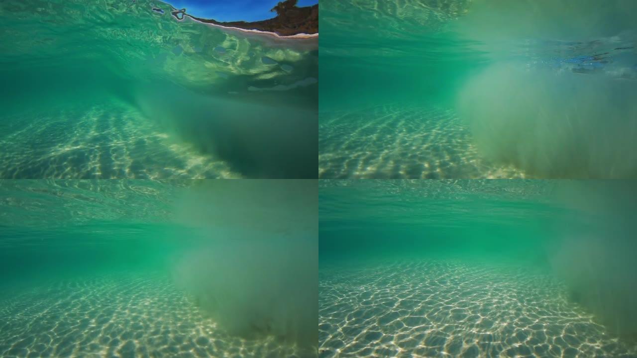 阳光穿透海水，带着柔和的波浪和运动，在沙滩上形成的水下光纹