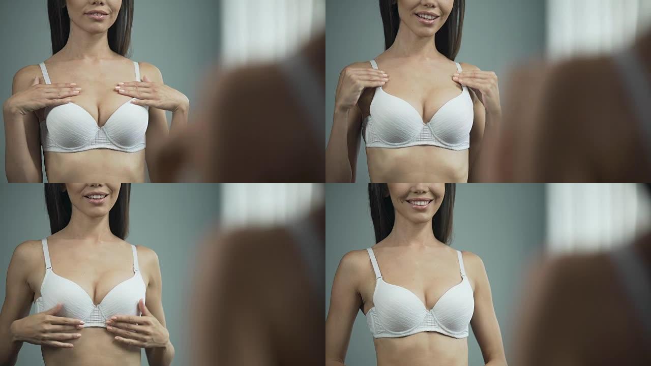 穿着白色胸罩的美丽亚洲女人在镜子附近摆姿势，整形手术，特写镜头