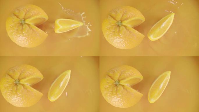 橙子在果汁上分裂成haslice lves。慢动作镜头