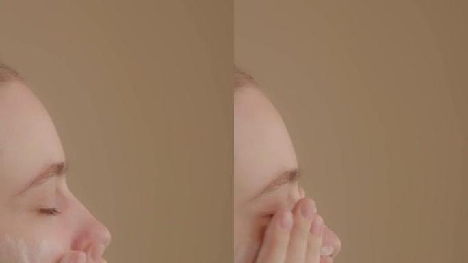 年轻女士用面部泡沫洗脸。侧视图，肖像