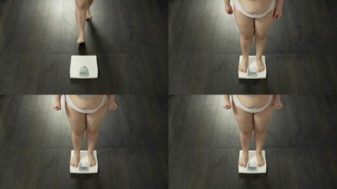 女人踩在浴室秤上测量体重，饮食不成功，失败