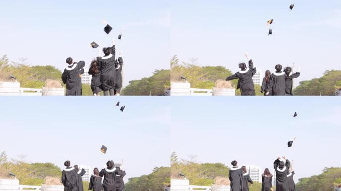 快乐的学生在空中奔跑和扔毕业帽