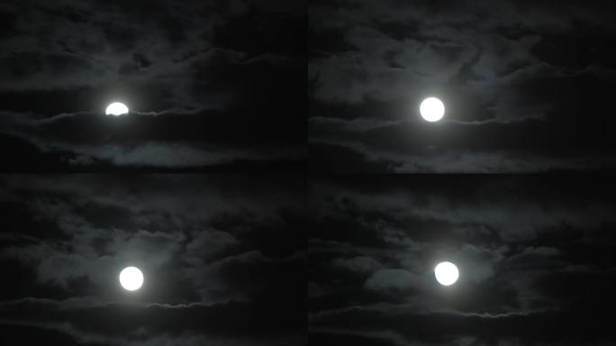 明亮的月球盘突破厚厚的云层，如善良试图击败邪恶