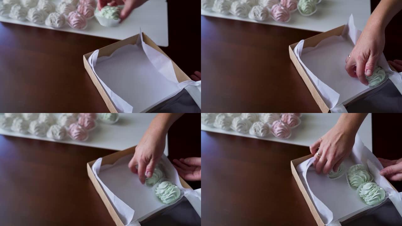 女糕点厨师在工艺盒中包装薄荷棉花糖特写手工概念