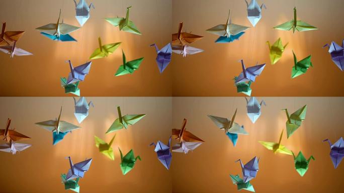 五颜六色的折纸鸟背景，纸鹤在风中摇曳，放松