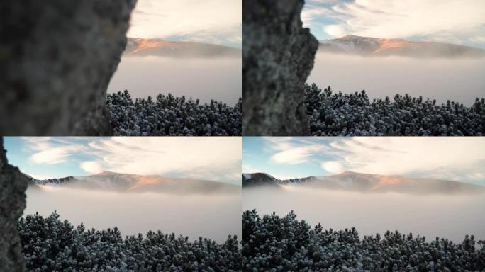 雪，云和雾在下面滚动的山脉的风景