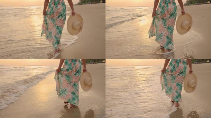 她在日落的海滩上散步。