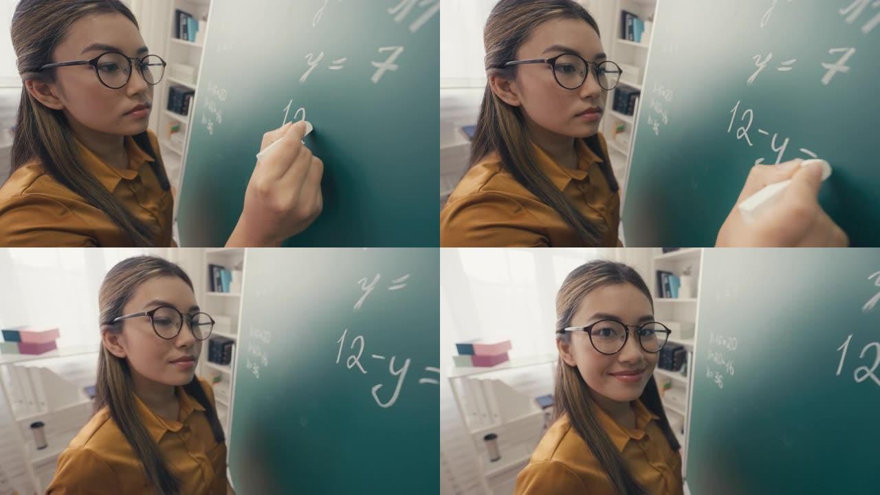 微笑的韩国女人写数学方程式的肖像，数学课