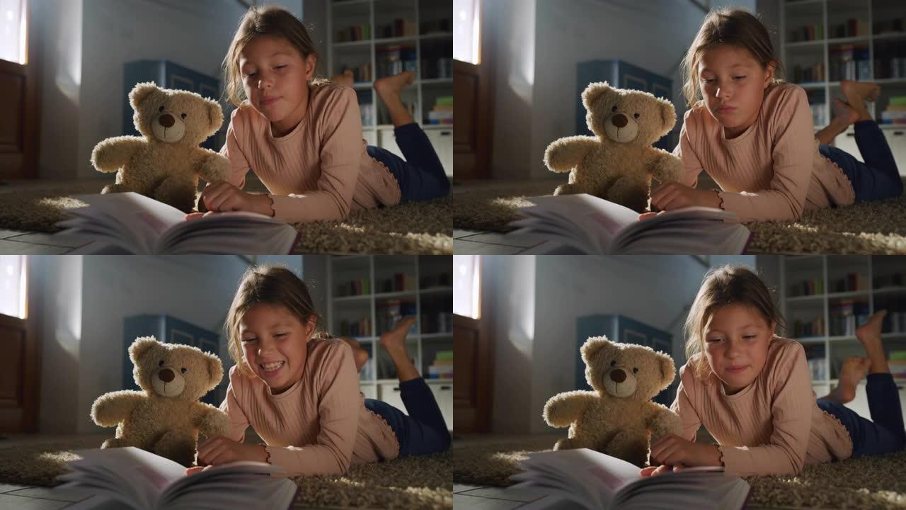 一个小女孩的肖像在晚上给她最喜欢的泰迪熊看书。快乐可爱的女孩玩她的玩具，讲故事。舒适氛围的童年概念