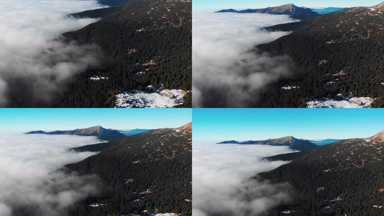云层上方雪山脊的空中无人机视图