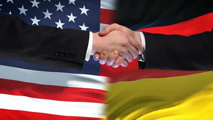 美国和德国握手，国际友谊，旗帜背景
