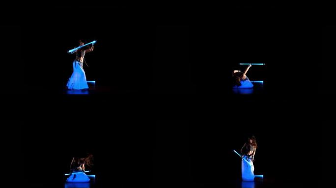 吉普赛黑发女人在紫外线下与霓虹灯舞动，舞蹈表演