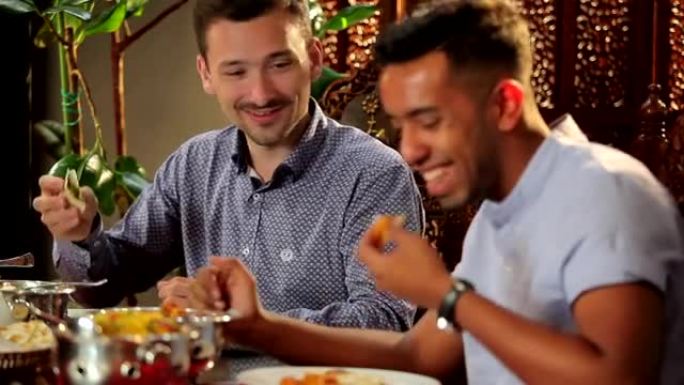 两名男子在印度餐厅吃皮塔饼