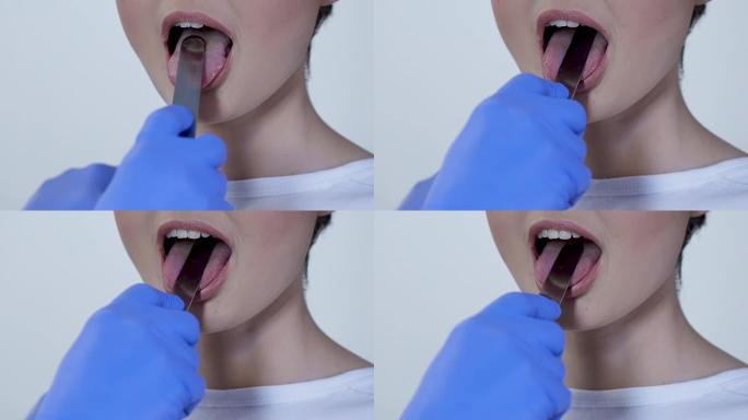 全科医生用医用压舌器检查患者的喉咙