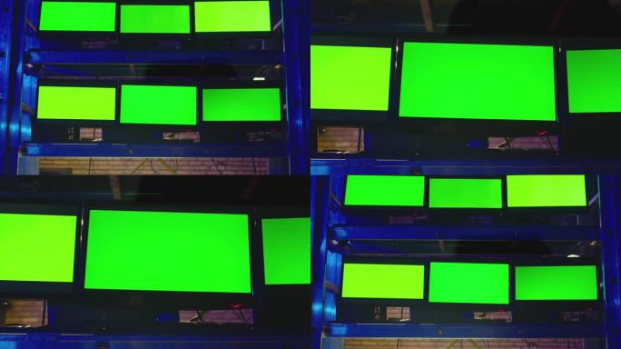 黑暗的现代房间里有很多绿色屏幕的显示器。监测、交易、分析室和保安系统的概念。视频切换器，电视控制处多