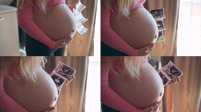 美丽的期待女人抚摸她怀孕的肚子和拿着超声波性别揭示她的宝贝孩子的照片，快乐的妈妈等待她心爱的孩子，美