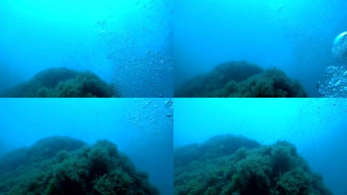 水下氧气气泡对抗悬崖和鱼，溺水的人的观点