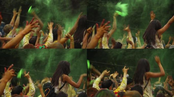 人们在节日，庆祝活动中向空中投掷五颜六色的油漆