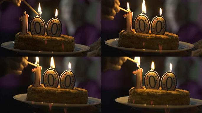 蛋糕上100的手工点燃蜡烛，公司周年庆典，仪式