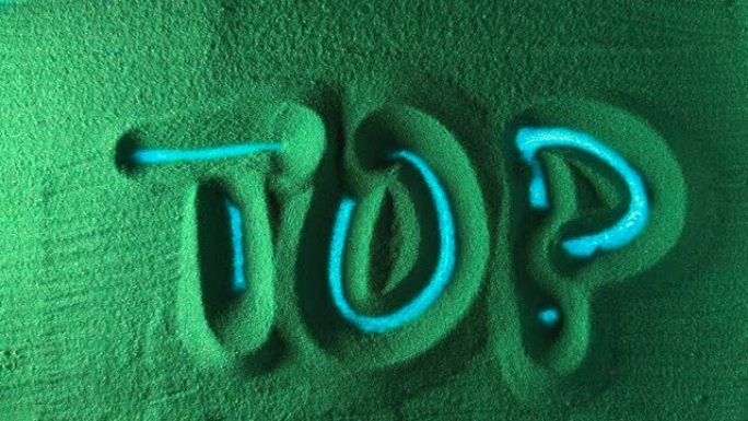 在绿色的沙滩上手工绘制单词Top。