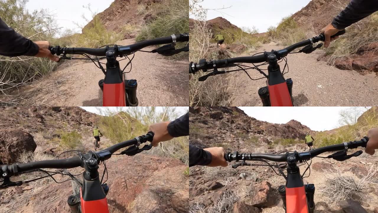 沿着沙漠小径骑自行车的第一人称视角