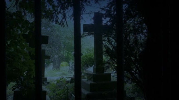 黄昏时穿过栏杆后面的墓地