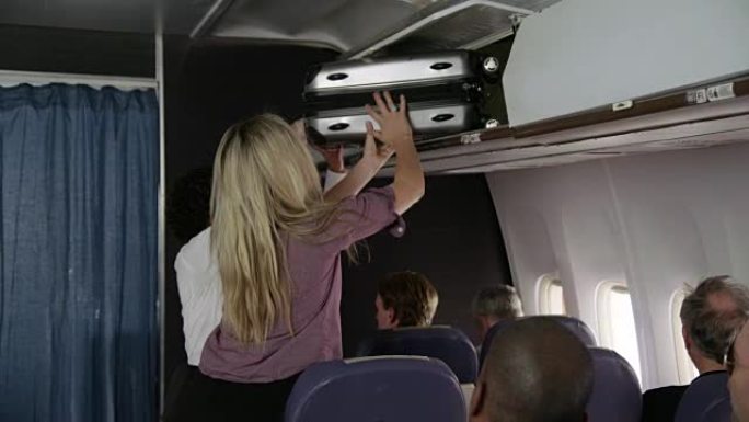 空姐帮助乘客提行李