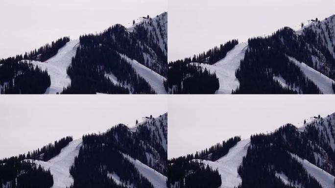 在阿斯彭高地滑雪场跑步的滑雪者的超级长焦视频。科罗拉多州阿斯彭。