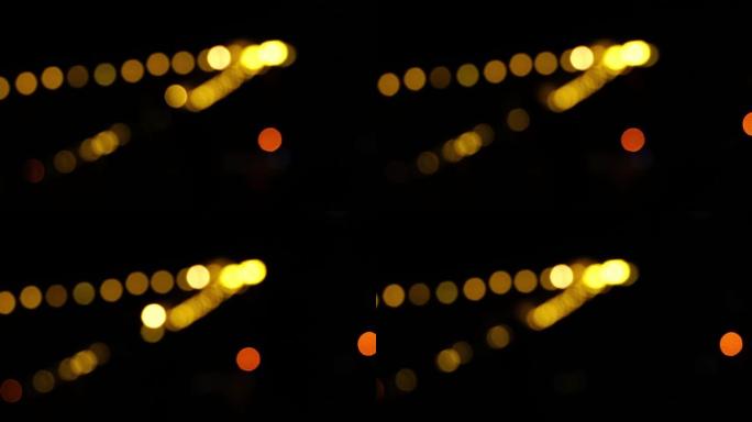 夜间黑暗模糊背景中的Bokeh，城市灯光的Bokeh，散焦的夜间交通信号灯，玻璃状圆形