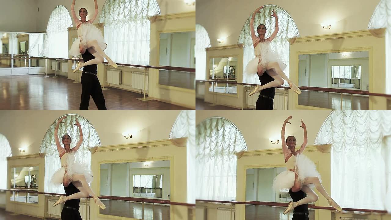 男芭蕾舞演员将芭蕾舞演员的手臂举在头顶上方