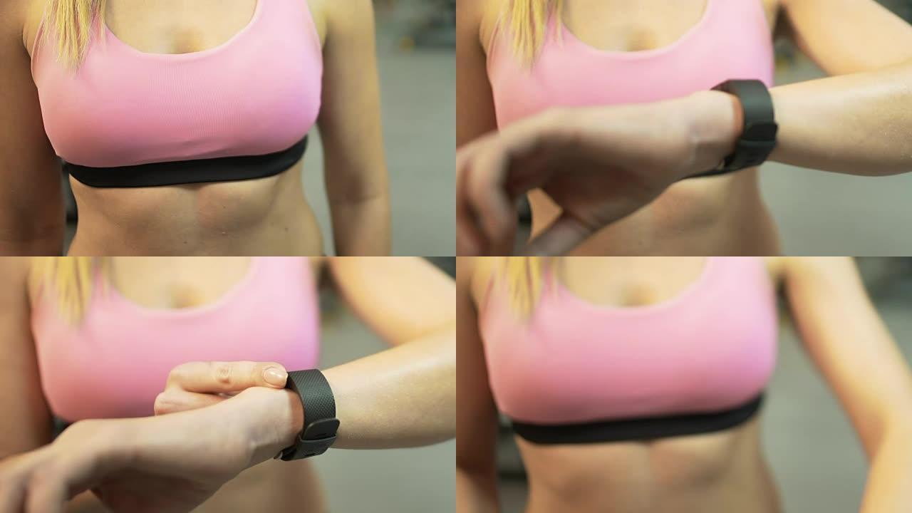运动女性在健身房开始锻炼前安装智能手表，积极生活
