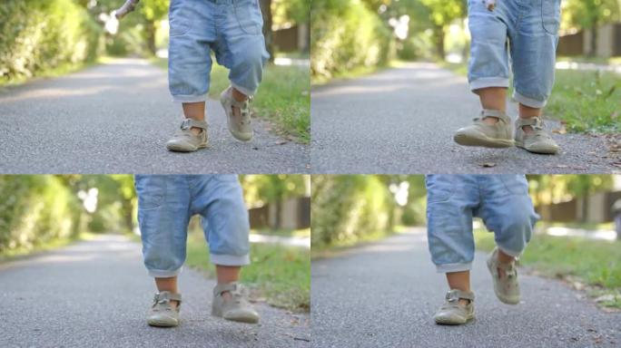 在人行道上行走的小孩的SLO MO DS腿