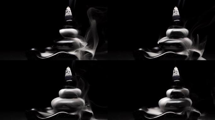 液体烟雾从阴燃的熏香锥中流出，用于冥想或瑜伽