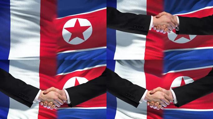 法国和朝鲜握手，国际友谊，国旗背景