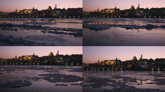 在寒冷的冬天下午，华沙市和维斯瓦河的无人驾驶飞机鸟瞰图被冰和桥梁覆盖