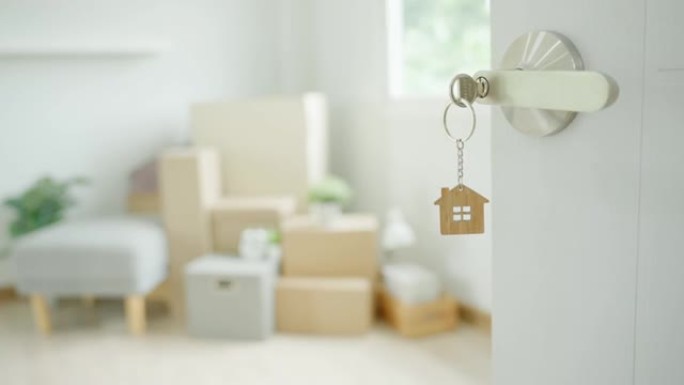 搬家，搬迁。钥匙插在新房子的门上，房间里是一个纸箱，里面装有个人物品和家具。搬进公寓或公寓