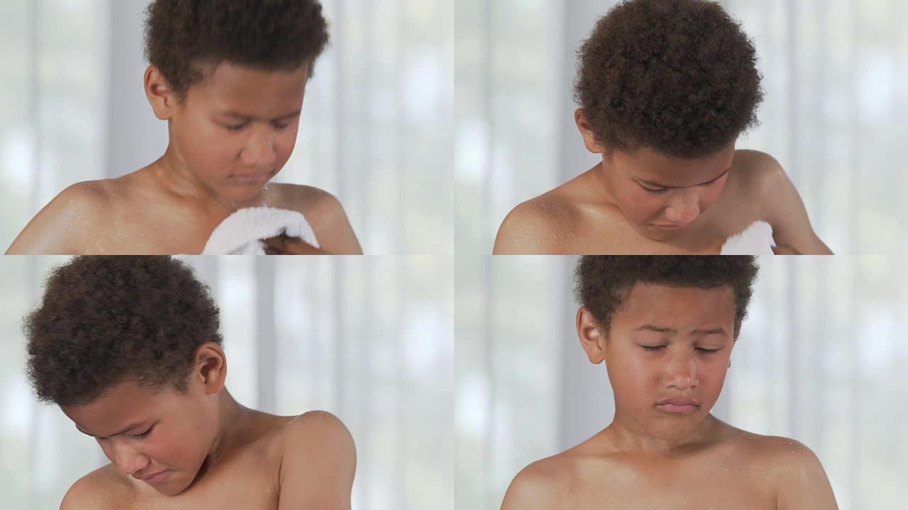 混血儿男孩用毛巾擦干自己，保持良好的卫生习惯，日常生活