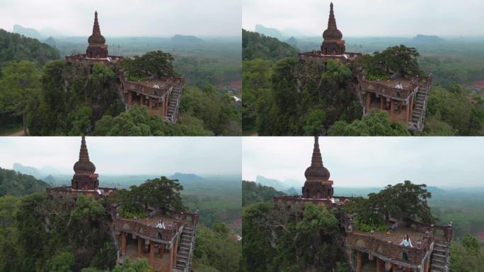 站在泰国丛林山上的佛教寺庙中的女人的鸟瞰图