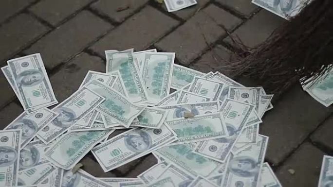 街道清洁工清扫并收集美元，货币贬值，危机